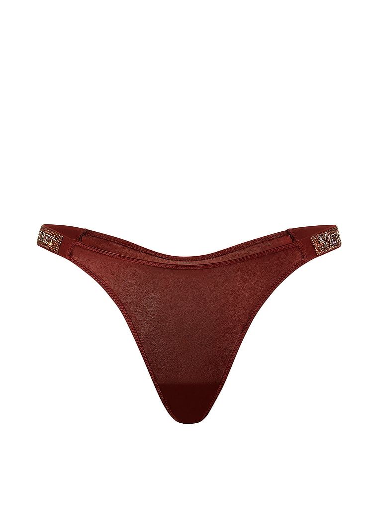 Tanga cu curele lucioase Shine Strap. Produsul este modelat și provine din colecția Very Sexy.