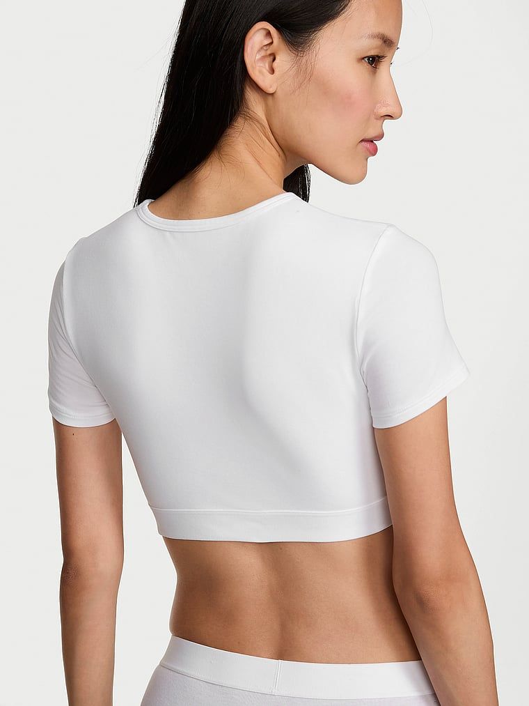 Bralette scurtă din bumbac cu mâneci scurte Shine Patch. Produsul este alb și provine din colecția de tricouri.