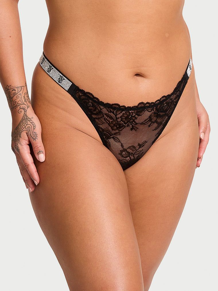 Tanga Shine Strap Rose Lace. Produsul este negru și provine din colecția Body by Victoria.
